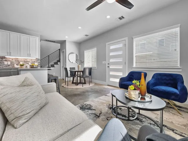 a living room with furniture and wooden floor