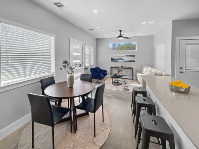 a view of a dining room with furniture and chandelier