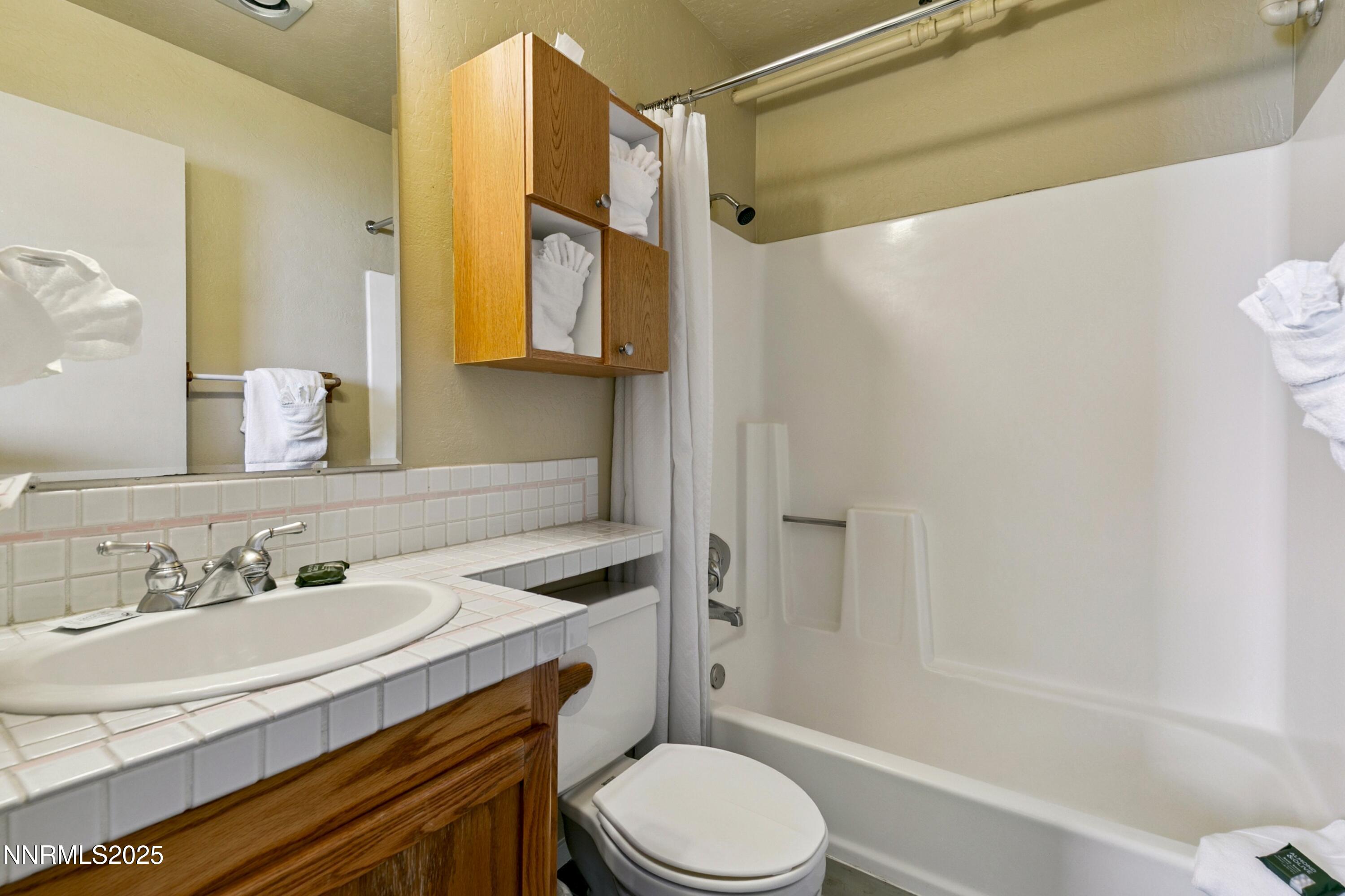 305 Galaxy Lane, Unit 5 Stateline, NV 89449 - Photo 18 of 56 a bathroom with a sink toilet vanity and shower