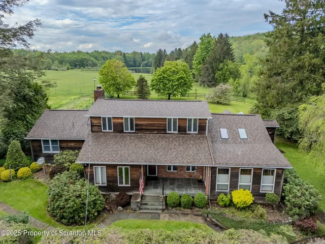 a view of house with backyard space and garden