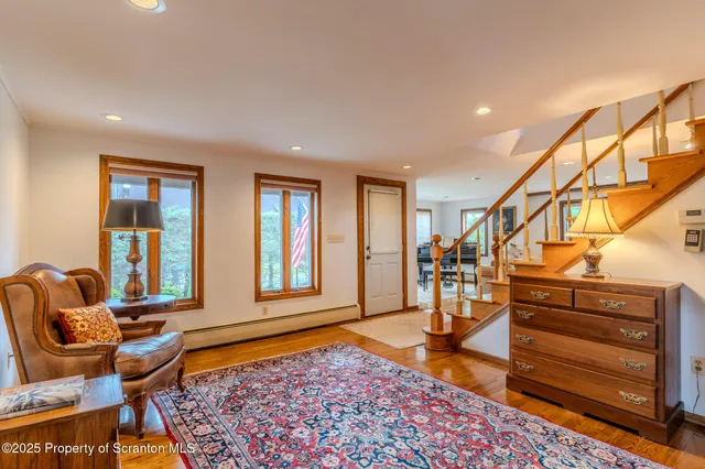 a view of an entryway with wooden floor