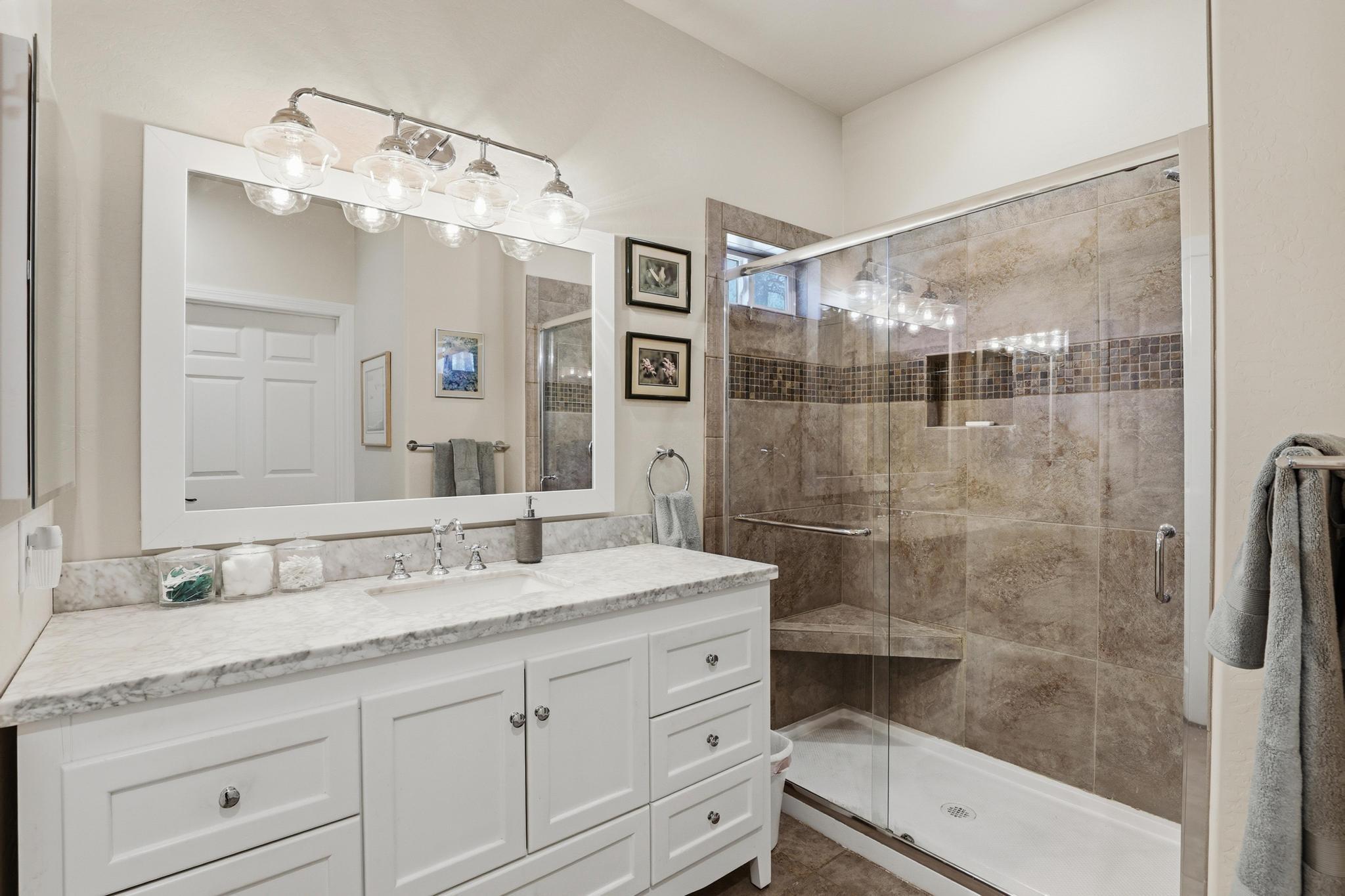 5501 Solitude Trail Loop Pine, AZ 85544 - Photo 22 of 27 a bathroom with a granite countertop sink mirror and shower