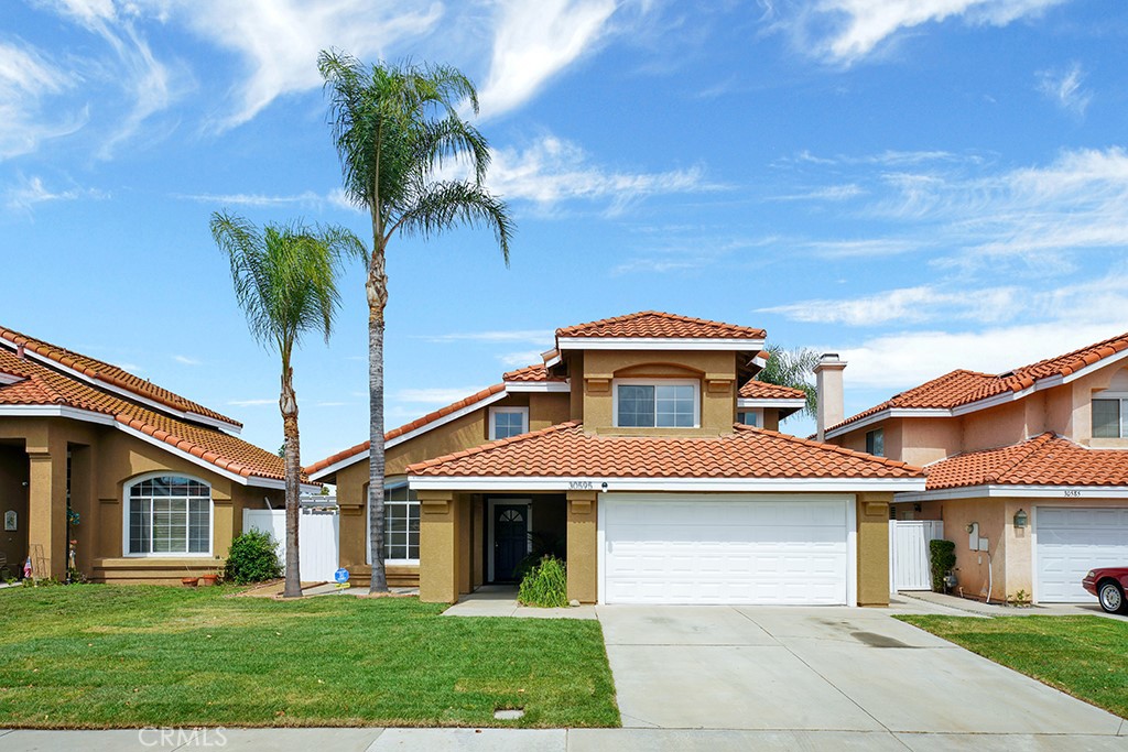 30595 Spring Deep Terrace Menifee, CA 92584 - Photo 1 of 1 a front view of a house with a garden