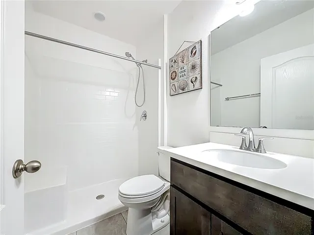 a bathroom with a bathtub a toilet and a shower