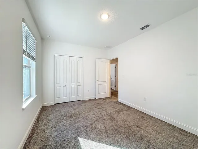 a view of a patio with a table and chairs under an umbrella