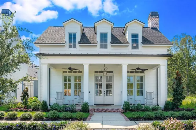 a front view of house with yard and trees in the background