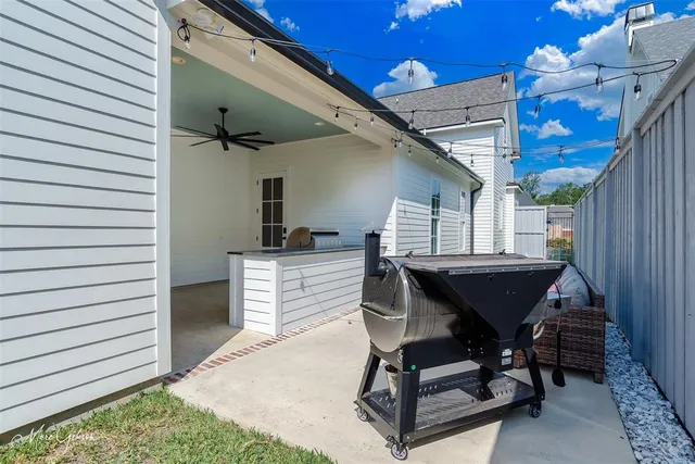 a view of a deck with table and chairs with wooden floor and fence