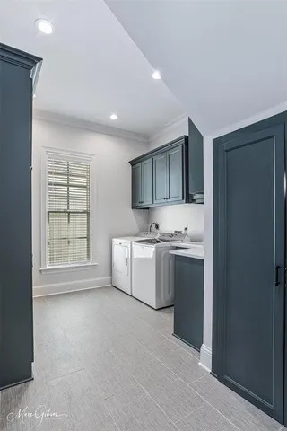 a large white kitchen with a sink and dishwasher a stove top oven with wooden floor
