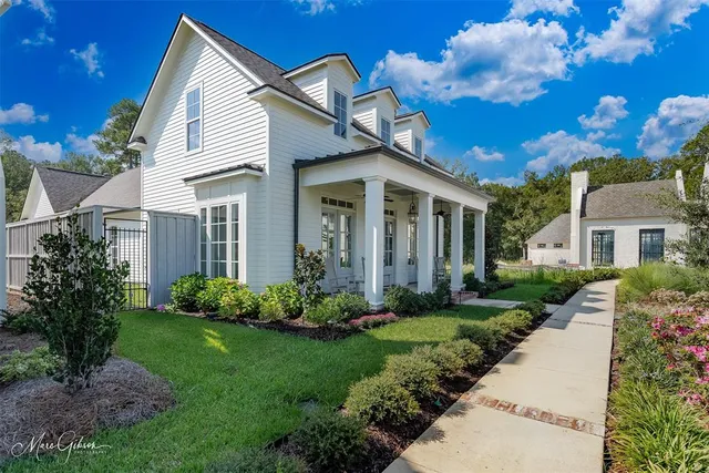 a front view of a house with a garden