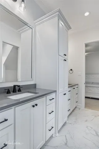 a bathroom with a granite countertop sink two mirror and a