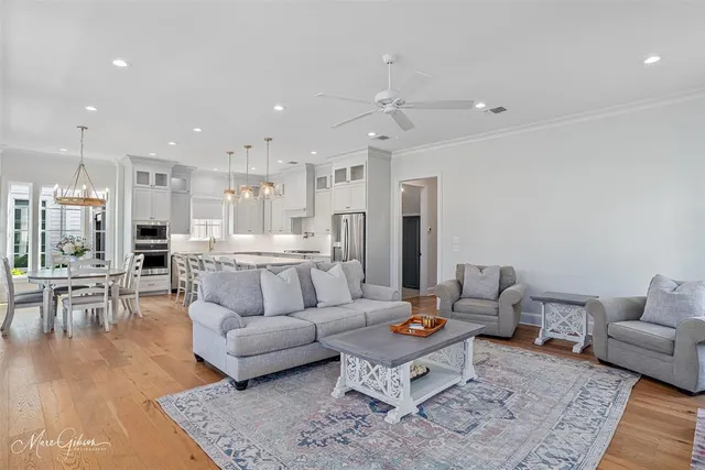 a living room with furniture and view of kitchen