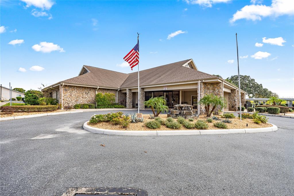 6366 Southwest 84th Lane Ocala, FL 34476 - Photo 30 of 40 a white house with a yard and table and chairs