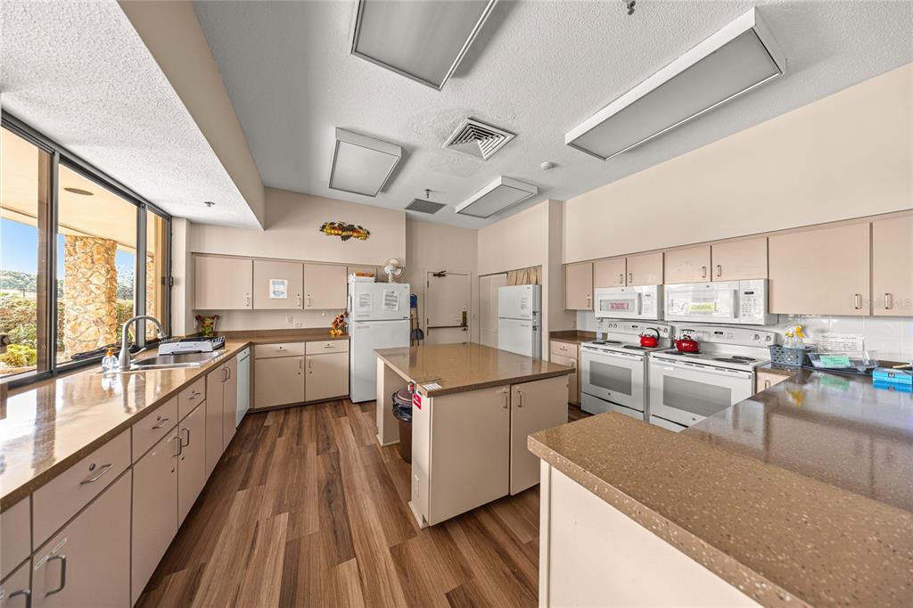 6366 Southwest 84th Lane Ocala, FL 34476 - Photo 35 of 40 a kitchen that has a lot of cabinets a sink and appliances in it