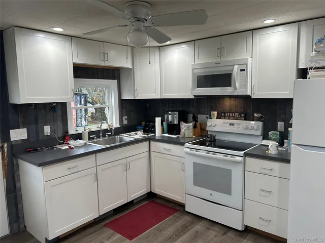 a kitchen with a sink stove and microwave