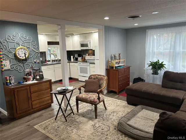 a living room with furniture and a clock