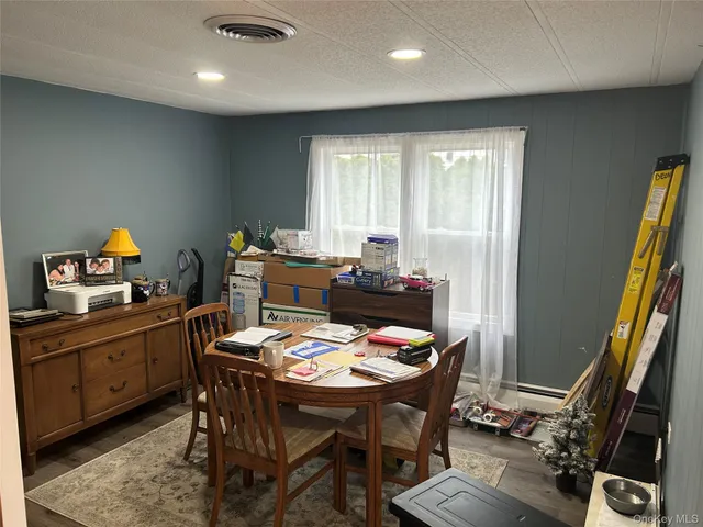 a dining room with furniture and window
