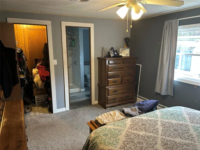 a bedroom with a bed and a mirror