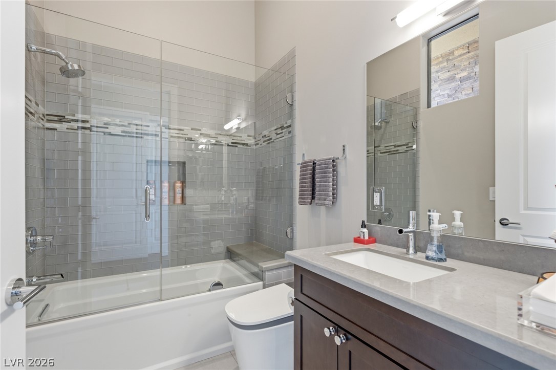 5 Crystal Tree Pass Henderson, NV 89052 - Photo 37 of 67 A refined bathroom featuring a contemporary vanity, large mirror, and tiled shower/tub combination.