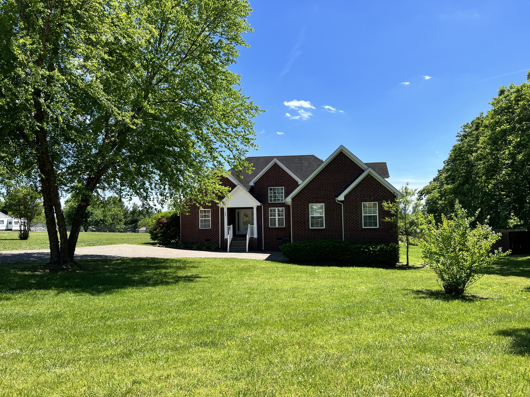 488 Fowler Ford Road Portland, TN 37148 - Photo 1 of 15 a front view of a house with a yard and trees