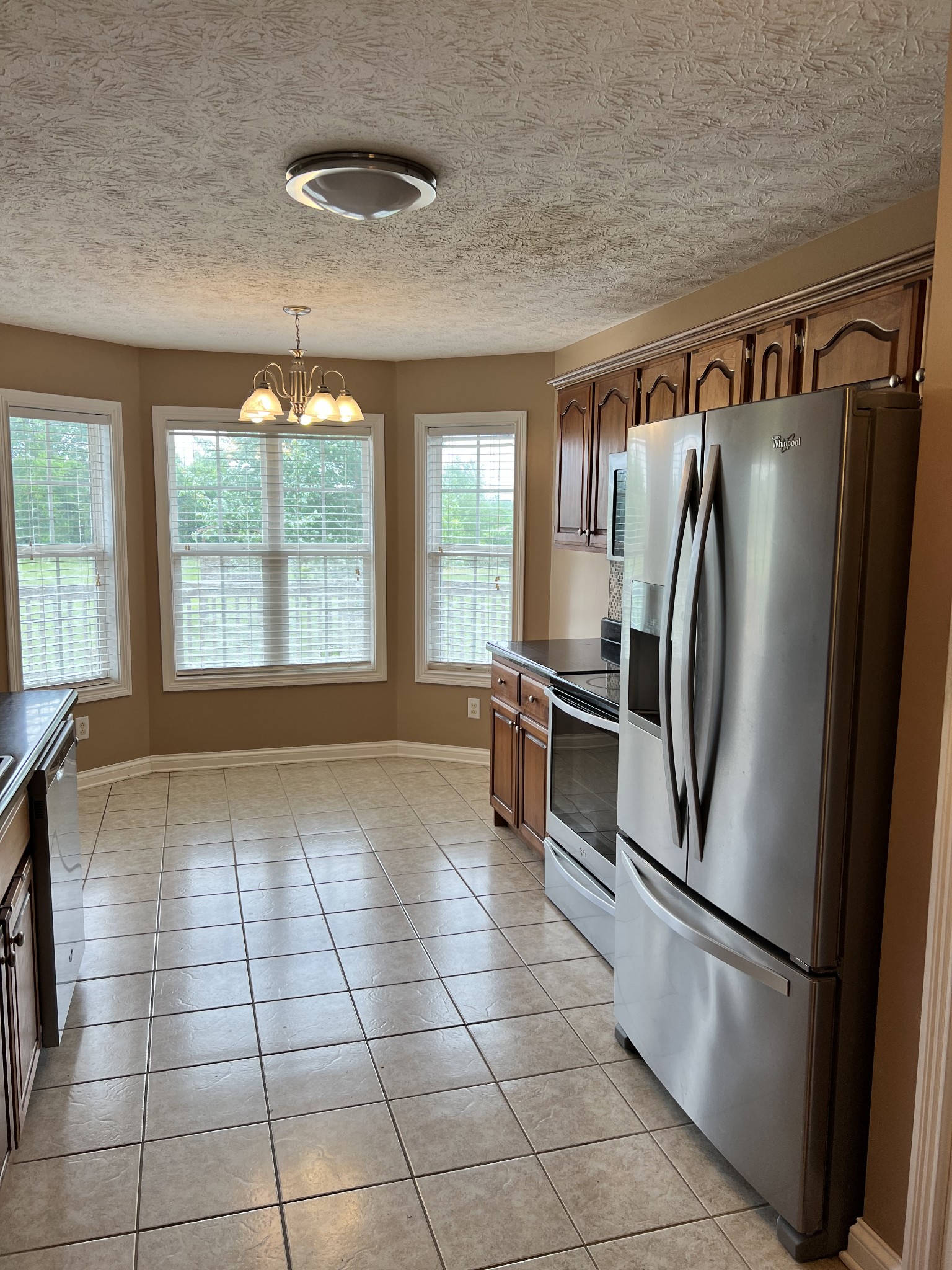 488 Fowler Ford Road Portland, TN 37148 - Photo 7 of 15 a kitchen with granite countertop a refrigerator and a stove top oven