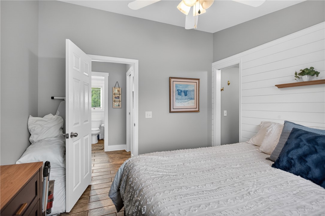 1230 Melton Road, Unit 4 West Union, SC 29696 - Photo 23 of 48 Well-lit sleeping quarters with rich wood-look flooring and a crisp accent wall.