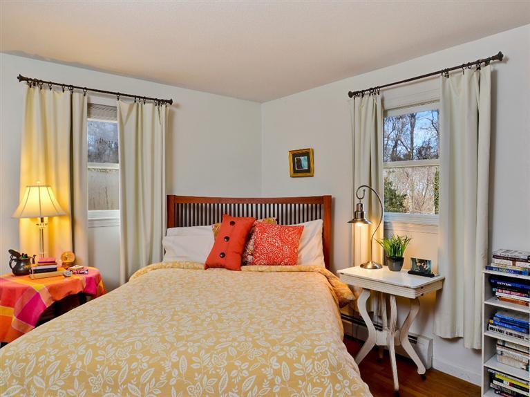 11 Crowell Road Sandwich, MA 02563 - Photo 6 of 19 a bedroom with a bed and a table in it with bedroom