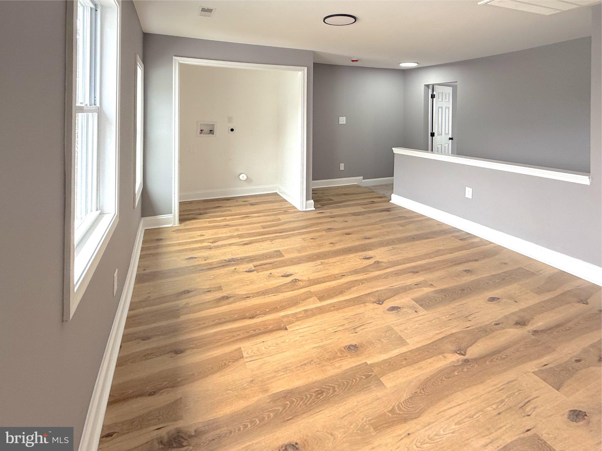 3703 6th Street, Unit 2 Baltimore, MD 21225 - Photo 11 of 20 Spacious, sunlit open living area.