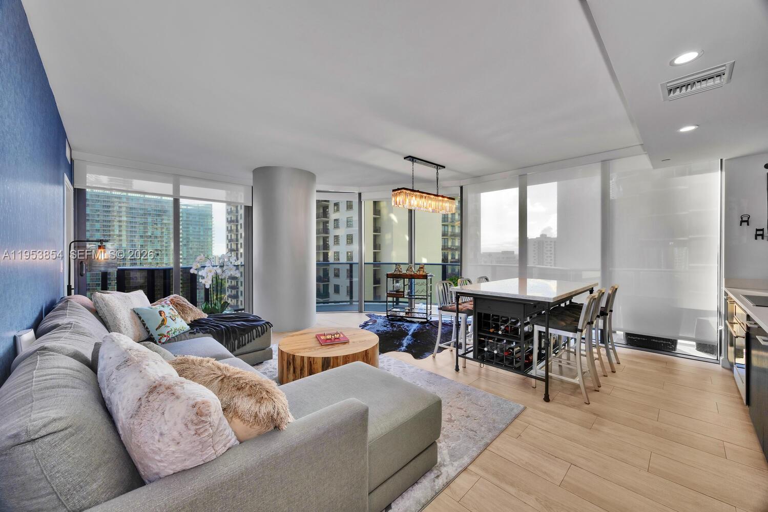 a living room with furniture and wooden floor