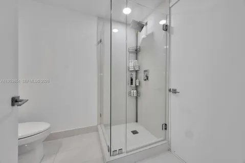a bathroom with a shower a toilet and a sink