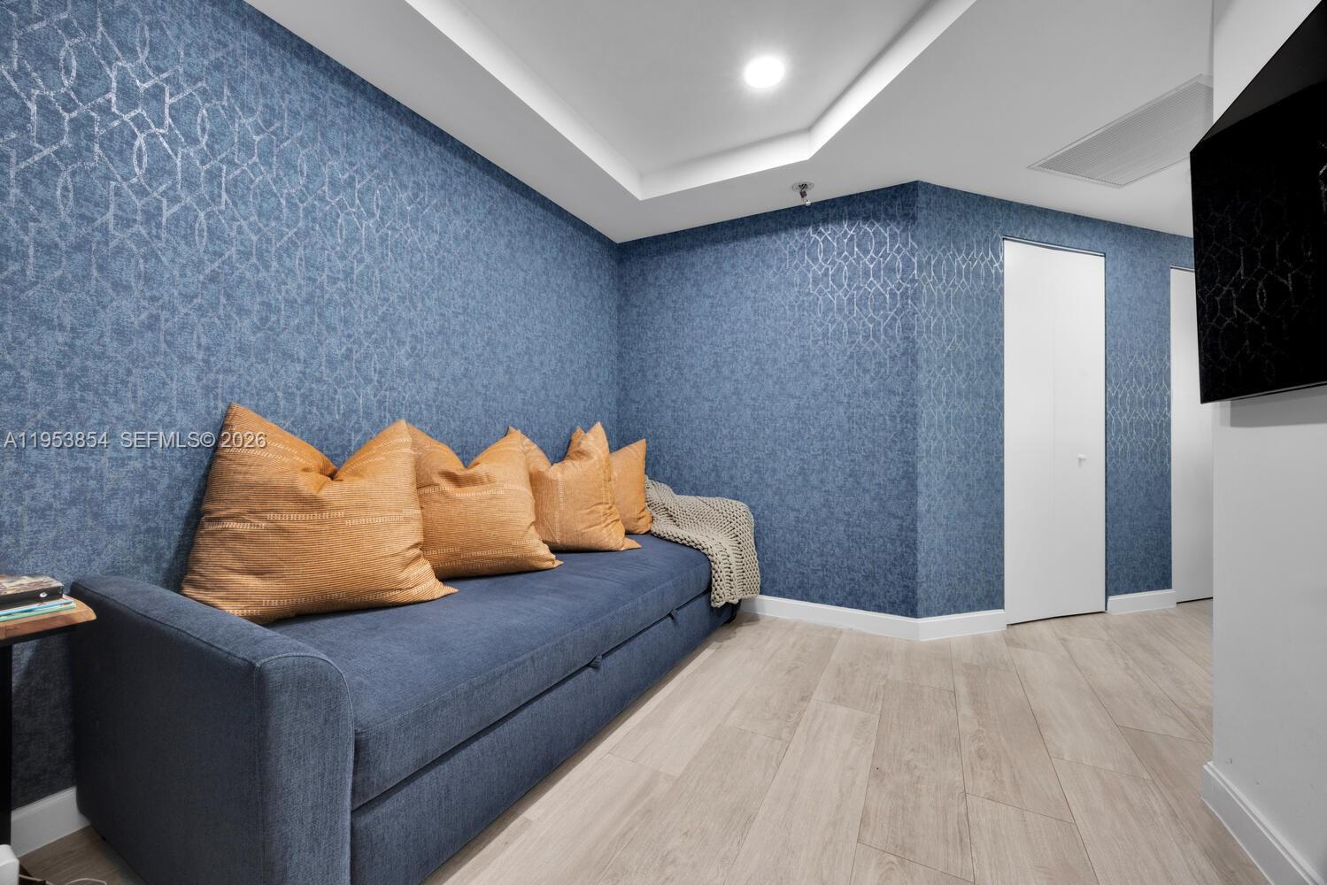 55 Southwest 9th Street, Unit 2406 Miami, FL 33130 - Photo 15 of 38 a bedroom with bed and a couch