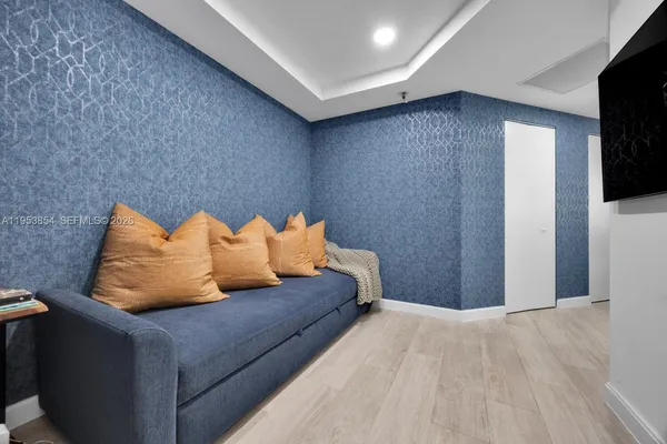 a bedroom with bed and a couch