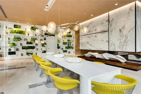 a bathroom with a granite countertop tub and a large mirror