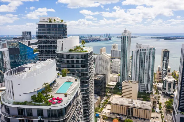 a view of roof deck with outdoor seating and city view