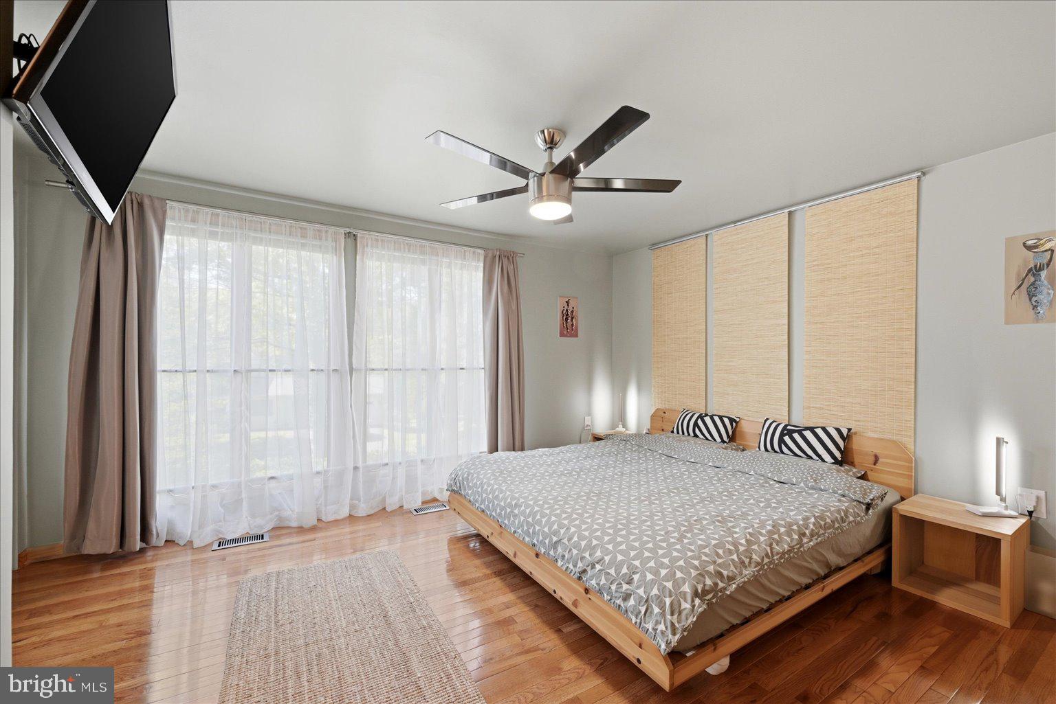 10929 Howland Drive Reston, VA 20191 - Photo 30 of 66 a bedroom with a large bed and a large window