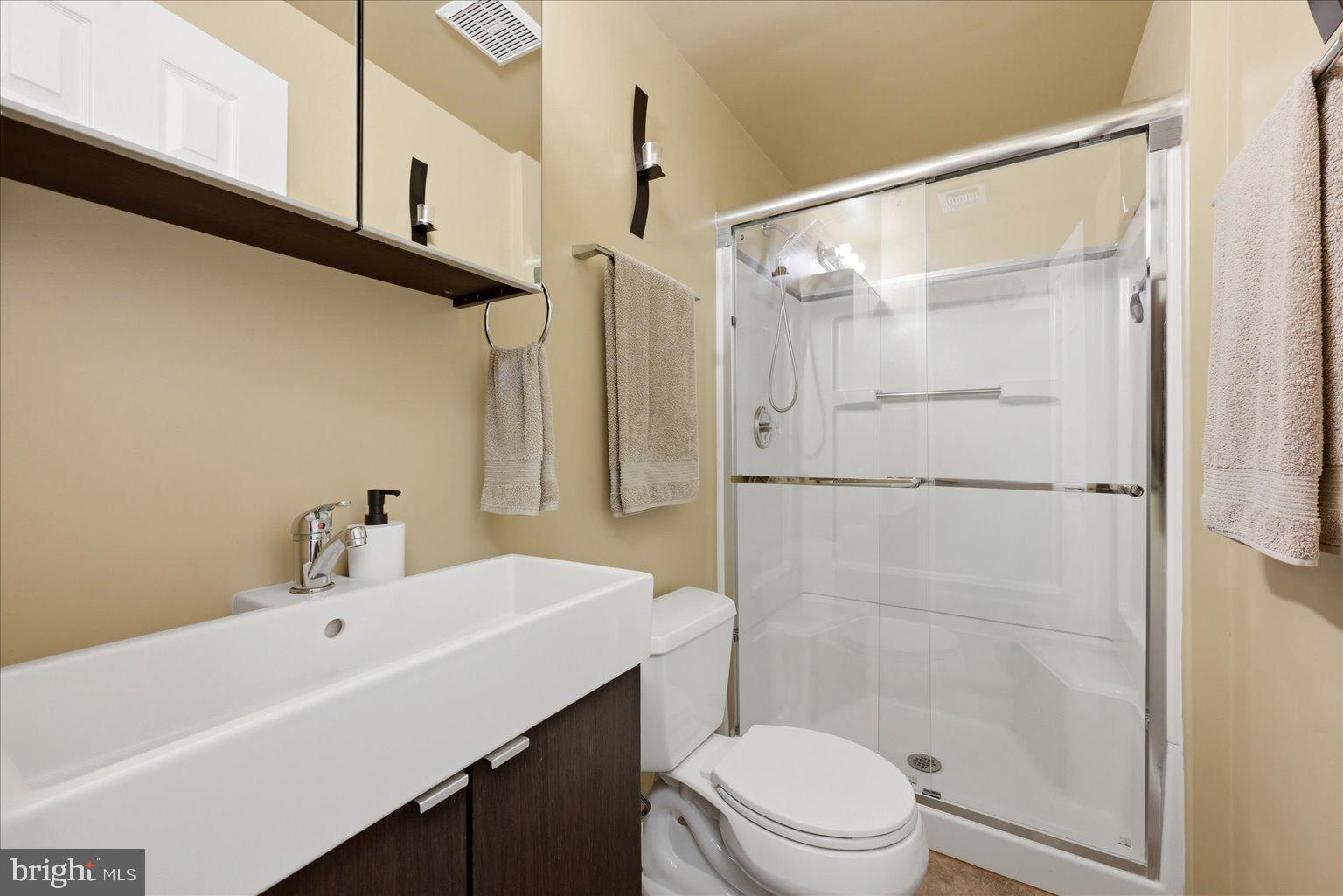 10929 Howland Drive Reston, VA 20191 - Photo 37 of 66 a bathroom with a sink a toilet and shower