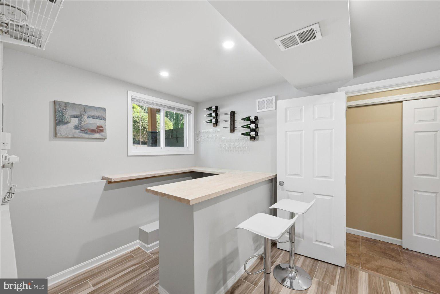 10929 Howland Drive Reston, VA 20191 - Photo 38 of 66 a view of a kitchen that has a sink a table and chairs in it
