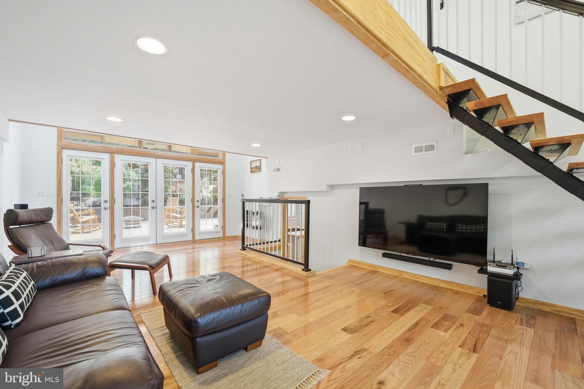 10929 Howland Drive Reston, VA 20191 - Photo 4 of 66 a living room with furniture tv and a floor to ceiling window