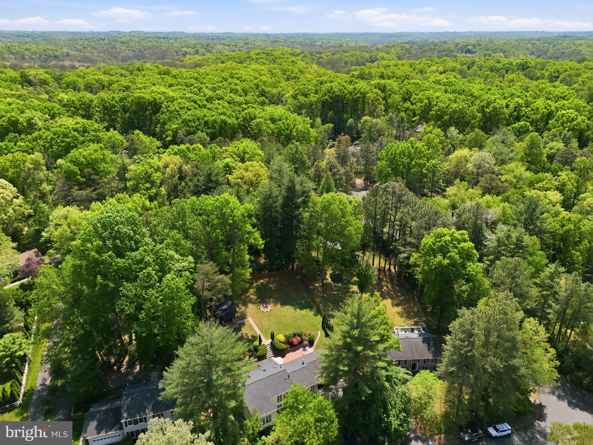 10929 Howland Drive Reston, VA 20191 - Photo 50 of 66 an aerial view of residential houses with outdoor space and trees
