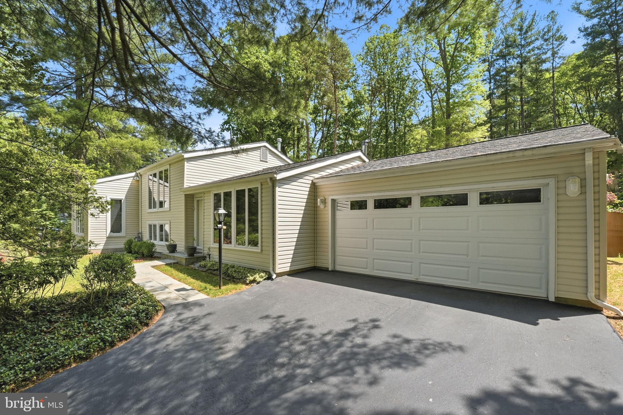 10929 Howland Drive Reston, VA 20191 - Photo 53 of 66 a front view of a house with a garden