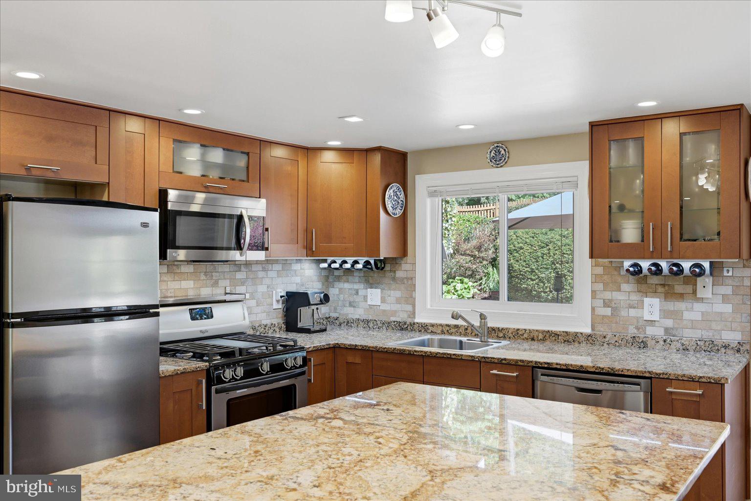 10929 Howland Drive Reston, VA 20191 - Photo 6 of 66 a kitchen with stainless steel appliances granite countertop a stove a sink and a microwave