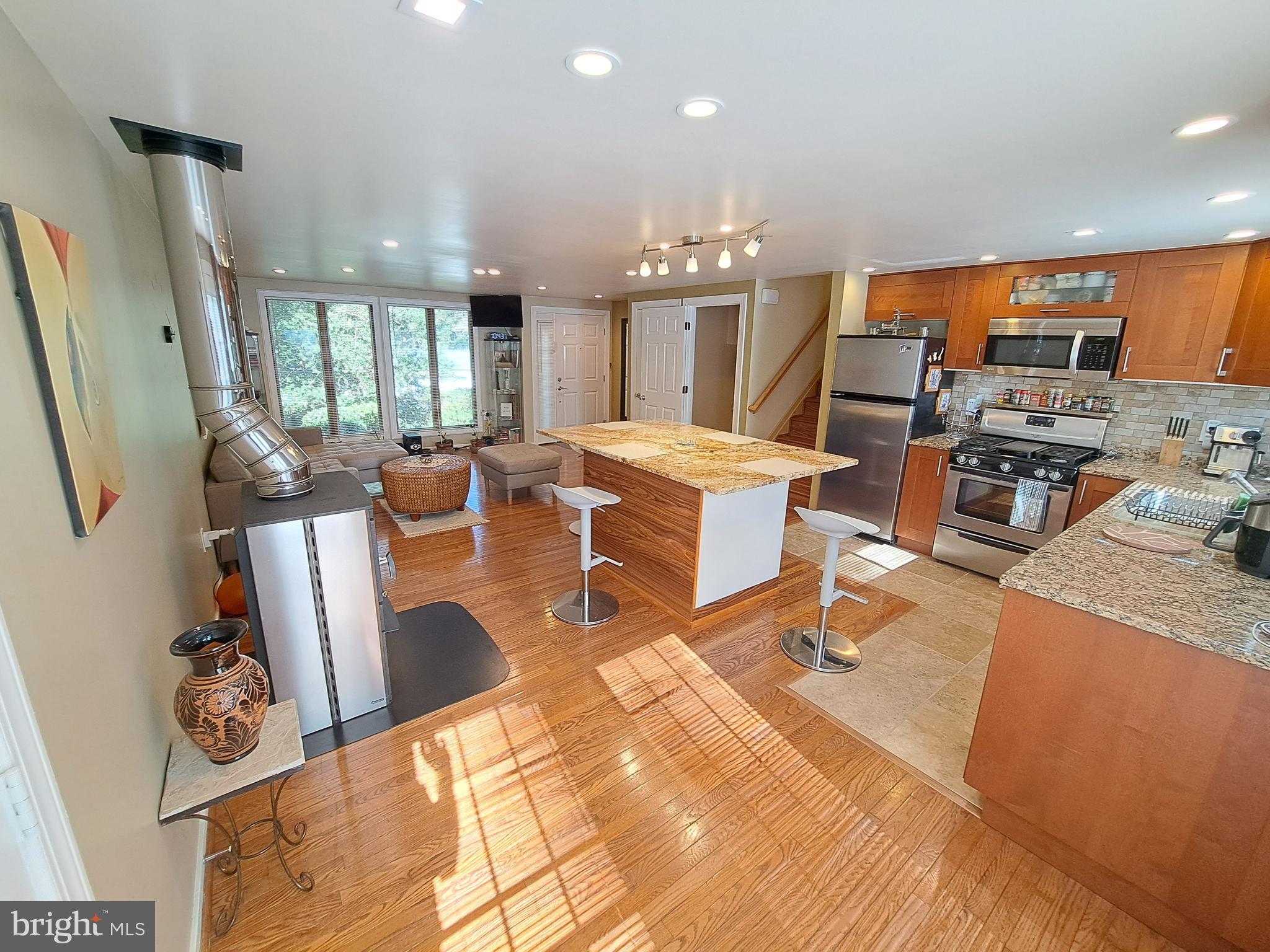 10929 Howland Drive Reston, VA 20191 - Photo 10 of 66 a living room with lots of furniture and kitchen view