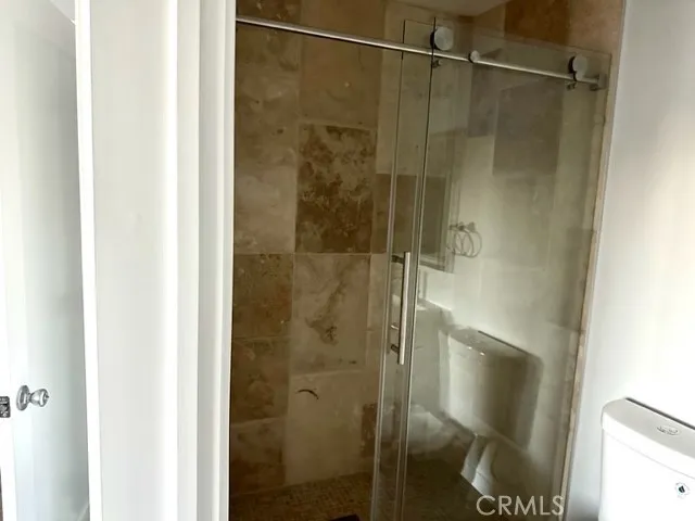 a bathroom with a glass shower door