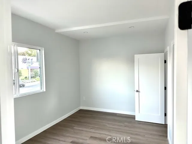 a kitchen with a refrigerator and white cabinets