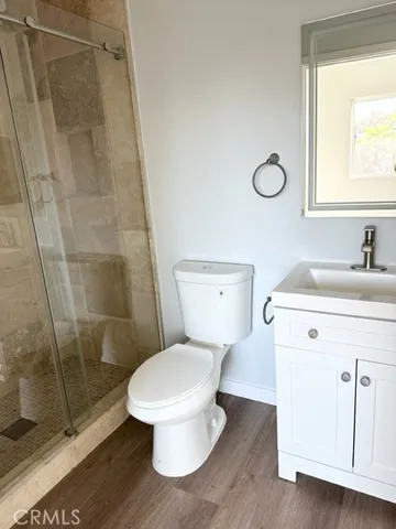 a bathroom with a toilet and a shower