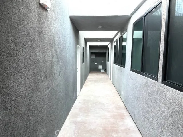 a kitchen with granite countertop a refrigerator and a stove top oven