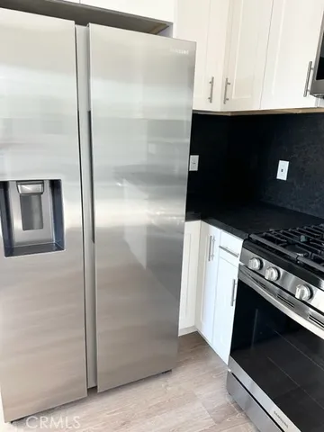 a kitchen with stainless steel appliances a sink and a refrigerator