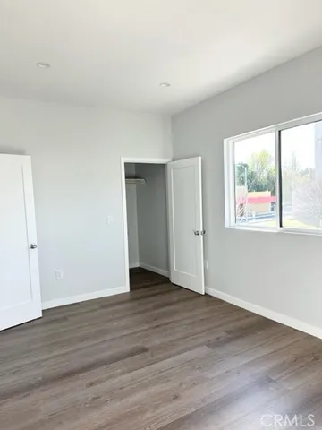 a view of walk in closet with wooden floor