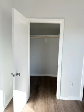 a view of an empty room and wooden floor