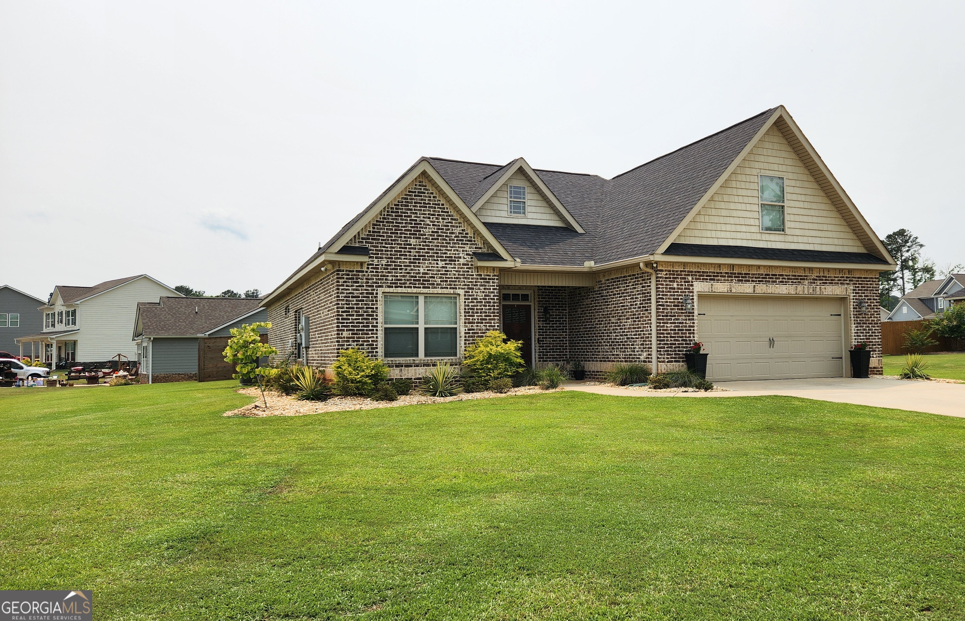 a front view of a house with a yard and garage