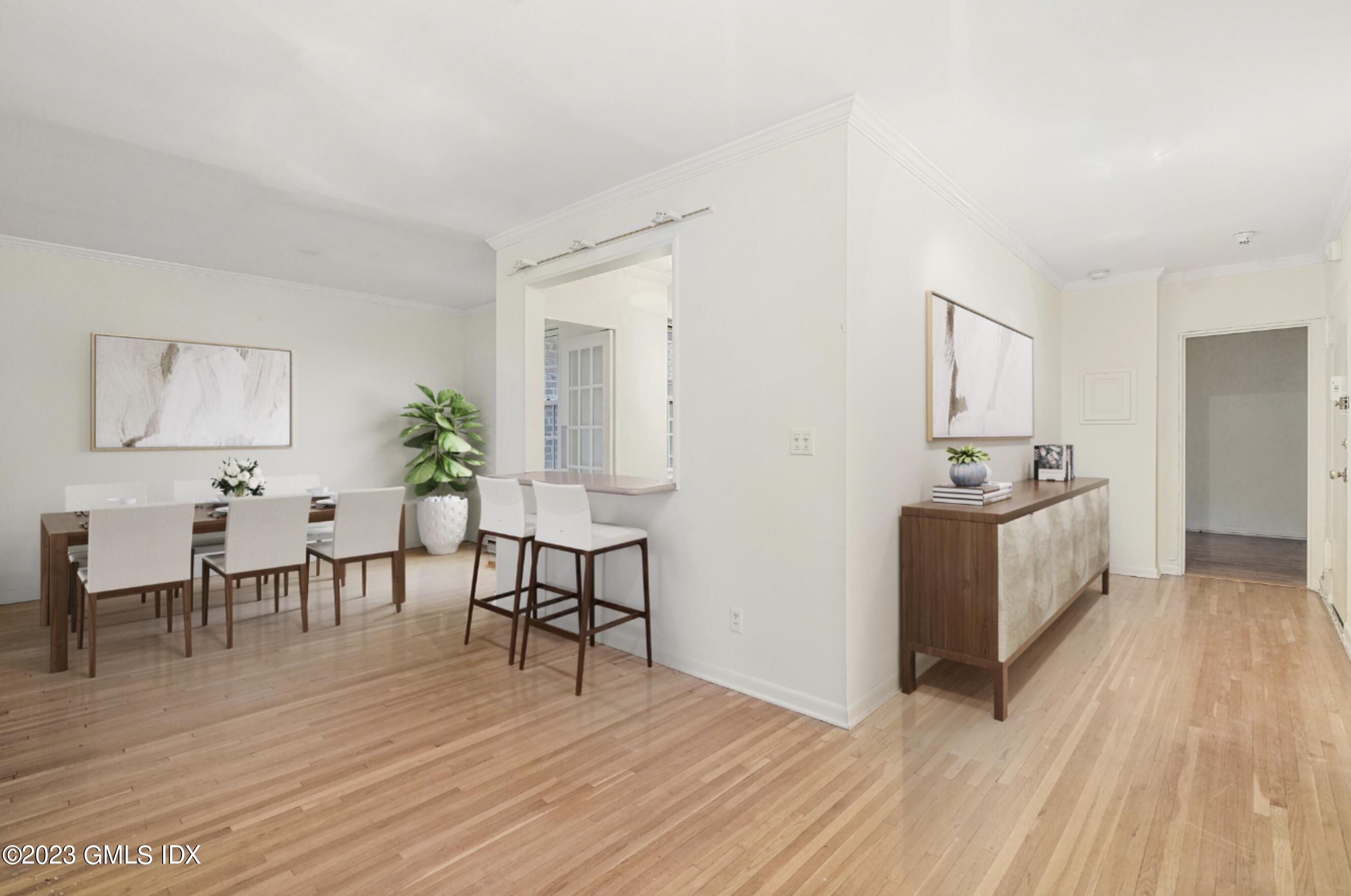 20 Church Street, Unit B35 Greenwich, CT 06830 - Photo 4 of 16 a living room with furniture and a wooden floor